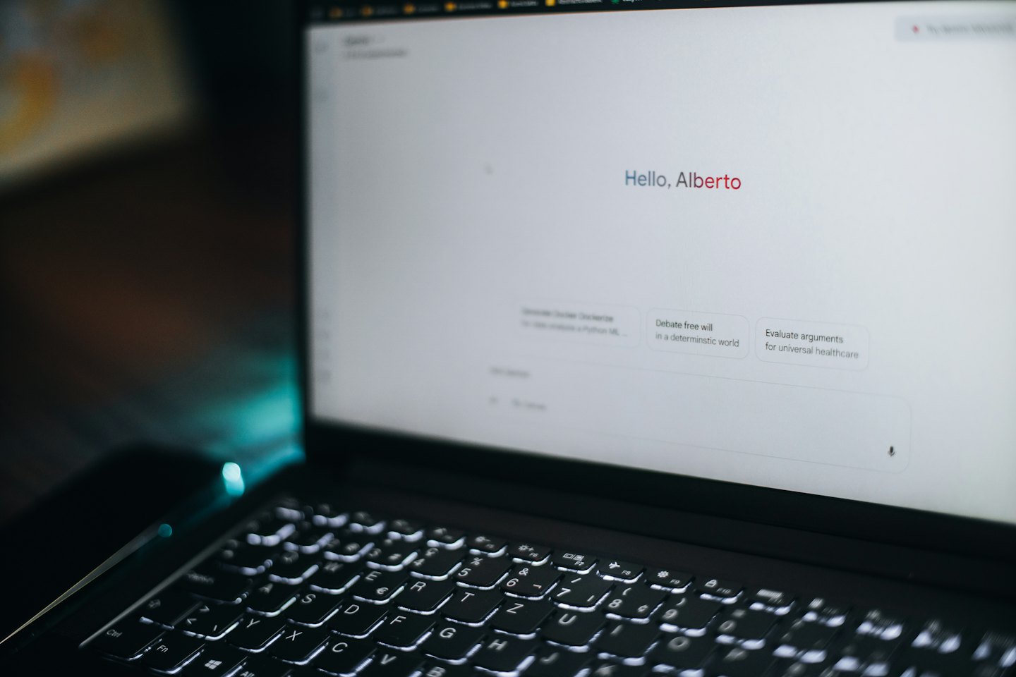 Laptop screen displays AI interface with greeting and prompts.
